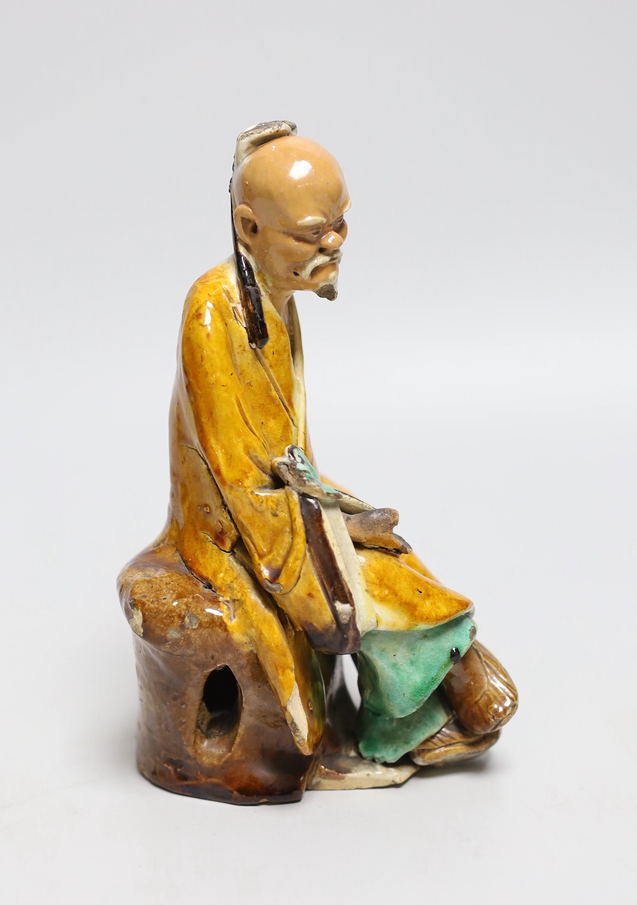 A Chinese Shiwan figure of a sage, possibly 18th century, 19cms high